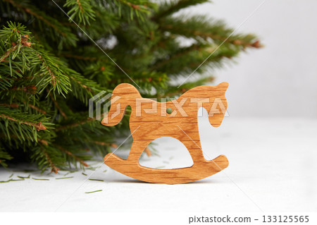 A decorative wooden rocking horse near the Christmas tree. A symbol of the New Year 2026 133125565