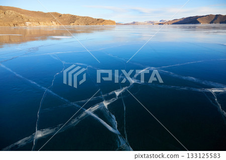Frozen Lake Baikal on a sunny winter day. Frozen Lake Baikal on a sunny winter day. 133125583