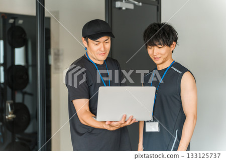 Sports gym, trainer in training gym, male instructor staff 133125737