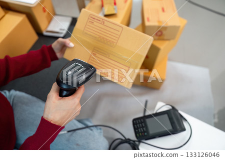 Logistics: Woman Scanning Package with Handheld Scanner 133126046