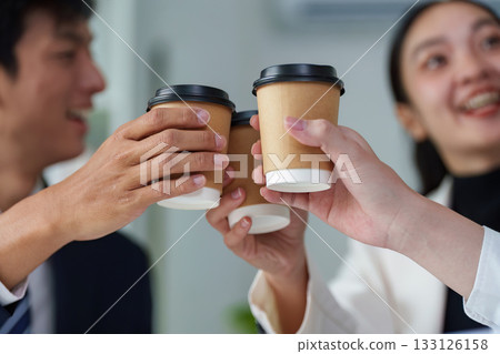 Team Collaboration. Colleagues toasting with coffee cups in office. 133126158
