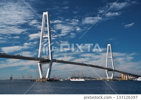 Nippon Maru passes under the Meiko Chuo Bridge and heads north towards Garden Pier Rinko. 133126397