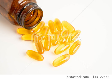 Fish oil or Cod liver oil gel in capsules with omega 3 vitamins, supplementary healthy food. 133127338