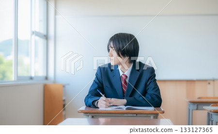 Male student looking outside during class 133127365