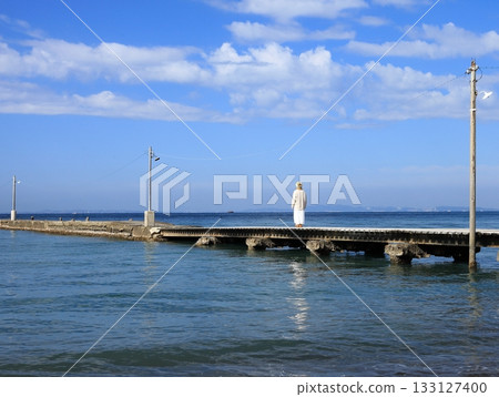 A woman walking on a pier 133127400