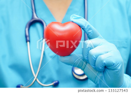 Asian woman doctor holding red heart for health in hospital. 133127543