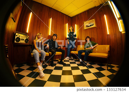 Four Friends Relax in a Vintage Lounge, Enjoying an Evening Together 133127634