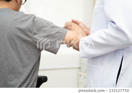 Physical therapy, Asian therapist doctor treat perform pain young man in hospital. 133127750