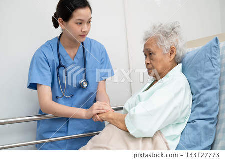 Asian doctor checking and treat elderly woman patient health in hospital. 133127773