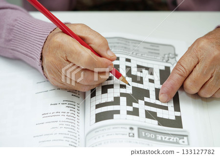 Bangkok, Thailand - May 15, 2022 elderly woman playing sudoku puzzle game. Bangkok, Thailand - May 15, 2022 elderly woman playing sudoku puzzle game. 133127782
