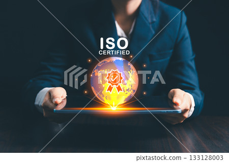 Businesswoman stands beside globe, representing modern global business practices where ISO standards, quality control, certification ensure product quality assurance, guarantee across market. Businesswoman stands beside globe, representing modern global business practices where ISO standards, quality control, certification ensure product quality assurance, guarantee across market. 133128003