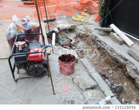 Construction work in historic center of European city, Italy. Replacement of old utility lines. Machinery and equipment. Construction work in historic center of European city, Italy. Replacement of old utility lines. Machinery and equipment. 133128056