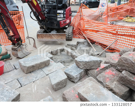 Construction work in historic center of European city, Italy. Replacement of old utility lines. Machinery and equipment. Construction work in historic center of European city, Italy. Replacement of old utility lines. Machinery and equipment. 133128057