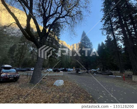 Yosemite rock face and Camp 4 parking lot illuminated by the morning sun Yosemite rock face and Camp 4 parking lot illuminated by the morning sun 133128200