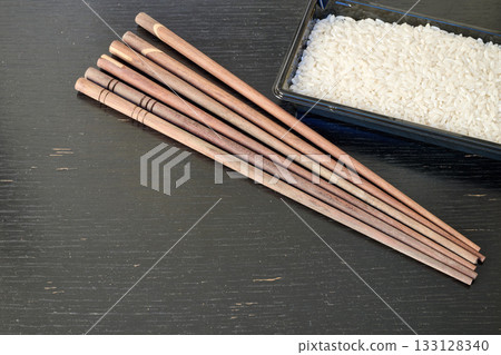 Rice, greek pasta and chopstick on black board Rice, greek pasta and chopstick on black board 133128340