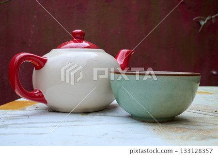 Teacup and bowl in garden 133128357