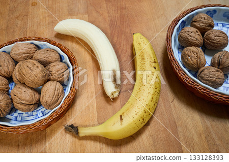 Yellow banana on wooden cutting board 133128393