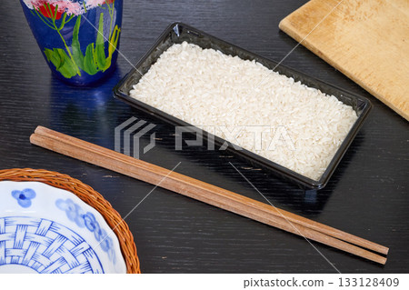 Rice, greek pasta and chopstick on black board 133128409