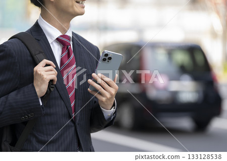 Hands of a businessman holding a smartphone Hands of a businessman holding a smartphone 133128538