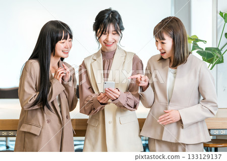 Businesswoman looking at smartphone in office (search, reservation, consultation meeting) 133129137