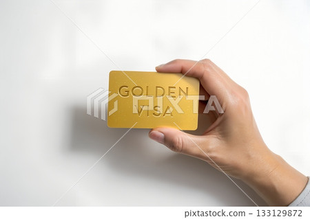 Unlock global opportunities with an exclusive golden visa, hand presenting financial freedom and luxurious access for international living 133129872