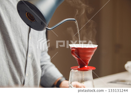 Barista Crafting Hand-Poured Drip Filter Coffee With Precision in Cozy Cafe Setting 133131244