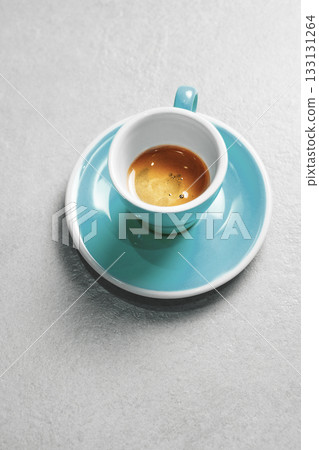 Turquoise Coffee Cup Filling With Rich Crema Espresso on Gray Surface of Table 133131264