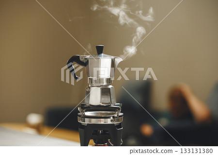Steam Rises From Bubbling Moka Pot While Brewing Rich Coffee Steam Rises From Bubbling Moka Pot While Brewing Rich Coffee 133131380