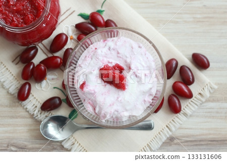 Dessert from cottage cheese and homemade preserved  jam from Cornelian cherry dogwood, lat. Cornus mas macrocarpa. 133131606