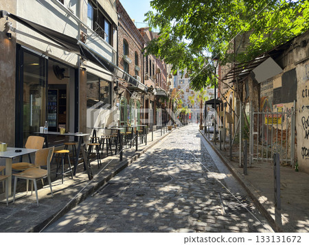 cobblestone street in Ladadika district of Thessaloniki, buildings cafe. Ladadika is a historic place near city old port. Greece 133131672