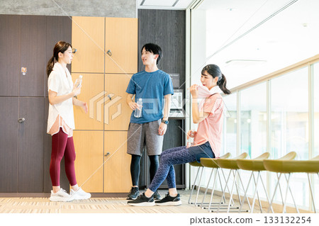 Men and women relaxing in the changing room Men and women relaxing in the changing room 133132254