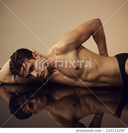 man with naked torso posing in studio 133132297