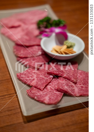 Various type of Japanese style sliced rare beef meat set on the plate, soft focus Various type of Japanese style sliced rare beef meat set on the plate, soft focus 133133083