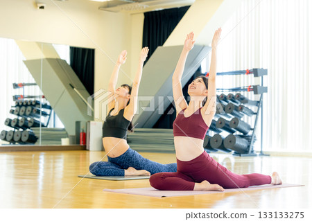 Young woman doing yoga in yoga studio 133133275