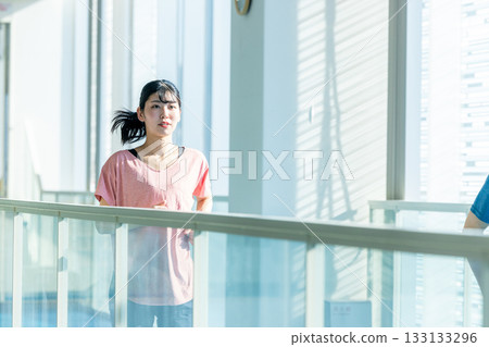Woman running on an indoor track 133133296