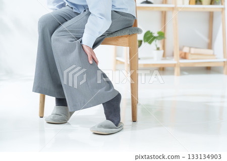 Woman with leg cramps 133134903