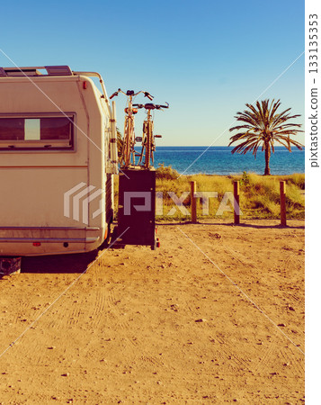 Camper with bicycles on beach, camping on sea Camper with bicycles on beach, camping on sea 133135353