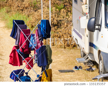 Clothes hanging to dry outdoors by camping car. Caravan vacation. Clothes hanging to dry outdoors by camping car. Caravan vacation. 133135357
