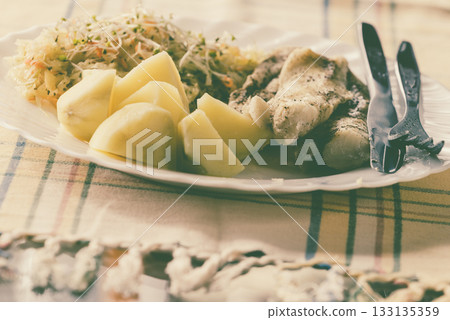 Dinner meal fish with salad and potatoes Dinner meal fish with salad and potatoes 133135359