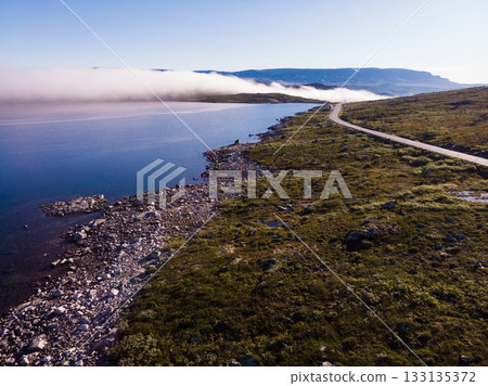 Road crossing Hardangervidda plateau, Norway. Aerial view. 133135372