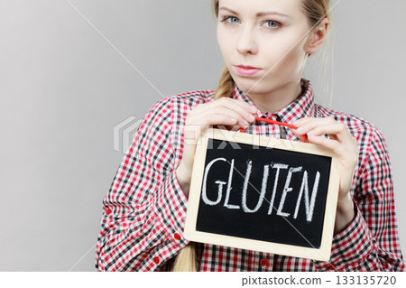 Woman holding board with gluten sign Woman holding board with gluten sign 133135720