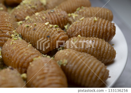 Lebanese recipe for Maakaroun fritters: fine wheat semolina, flour, butter, oil, ground anise Lebanese recipe for Maakaroun fritters: fine wheat semolina, flour, butter, oil, ground anise 133136256
