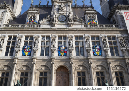 City Hall of Paris, France building adorned with colorful flags and rich architecture 133136272