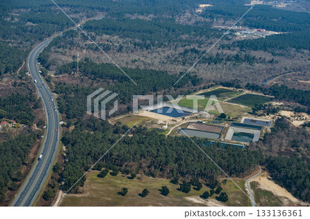 Aerial view of water treatment facilities surrounded by lush greenery 133136361