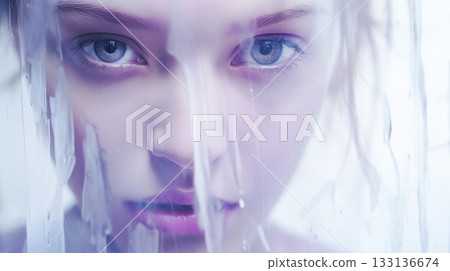 Surreal close up portrait of young woman with water reflections on her face 133136674