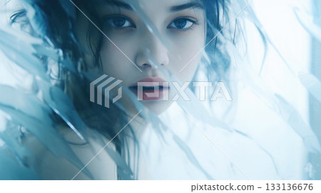 Surreal close up portrait of young woman with water reflections on her face 133136676