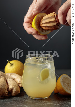 Ginger Ale with ice and lemon on a black background. 133136741