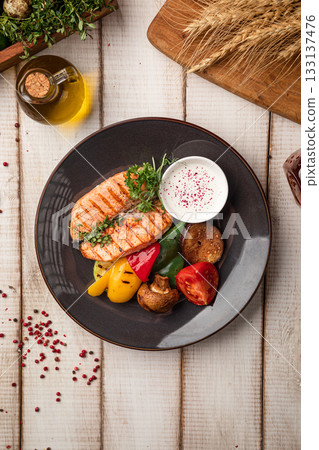 Grilled salmon steak with vegetables 133137476