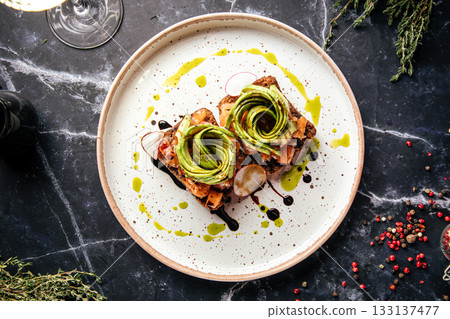 Avocado toast with gourmet toppings Avocado toast with gourmet toppings 133137477