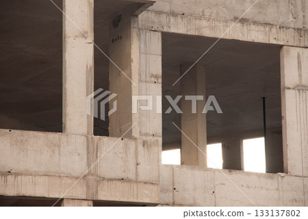 Concrete Wall Frame of Building under Construction. Formwork Prints on Surface with Fittings Release from Monolithic box, with window hole at Construction Site. Architectural origin of Structure. Concrete Wall Frame of Building under Construction. Formwork Prints on Surface with Fittings Release from Monolithic box, with window hole at Construction Site. Architectural origin of Structure. 133137802